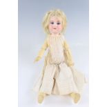 An Armand Marseille bisque headed and painted pine doll, having sleeping eyes and articulated limbs,