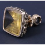 An ornate Victorian citrine set fob seal, having a vacant 14.5 x 16.5 mm matrix with faceted