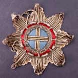 An antique bullion-embroidered star breast badge, 10 cm