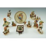 Nine Goebel figurines together with a 1976 plate and a wall clock, plate 19 cm