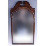 A 1930s Queen Anne influenced mahogany mirror, having a swan neck crest, 72 x 39 cm