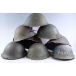 Four British Mk 4 steel helmets together with six shells