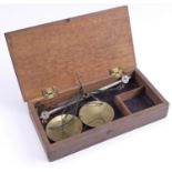 A late 19th Century cased set of pocket scales, the wooden case bearing an old Sotheby's Belgravia