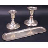 A 1930s silver pin tray and two candle holders, Birmingham 1937, 1937 and 1926, candle holders