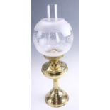 A late 20th Century brass twin wick oil lamp, having a frosted and floral decorated glass globe,