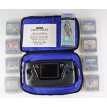 A SEGA Game Gear hand-held video game console, together with a case, charging wire, instructions,