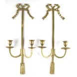 A pair of late 20th Century brass wall hanging candle brackets with ribbon bow surmounts, 47 cm