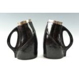 Two George V Doulton Lambeth silver mounted blackjack jugs, each moulded in representation of the