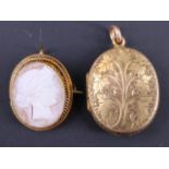 An Edwardian yellow metal double locket, floral engraved front and verso and bearing 'Dollie',