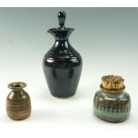 Three items of late 20th Century studio pottery comprising a carafe, squat vase and a pot, carafe 29