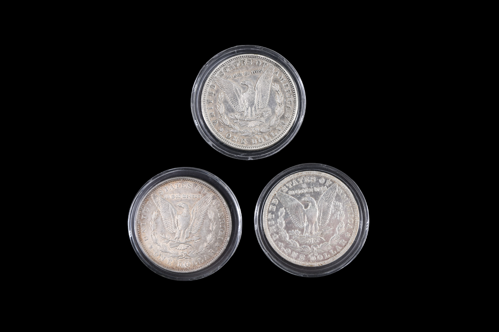 Three silver US "Morgan Dollar" coins, comprising an 1884 San Francisco, an 1885 New Orleans, and an - Image 3 of 3