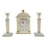 A Past Times mantle clock together with a pair of conforming candlesticks, clock 20 cm