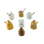 Six beehive honey pots together with another similar, tallest 12 cm