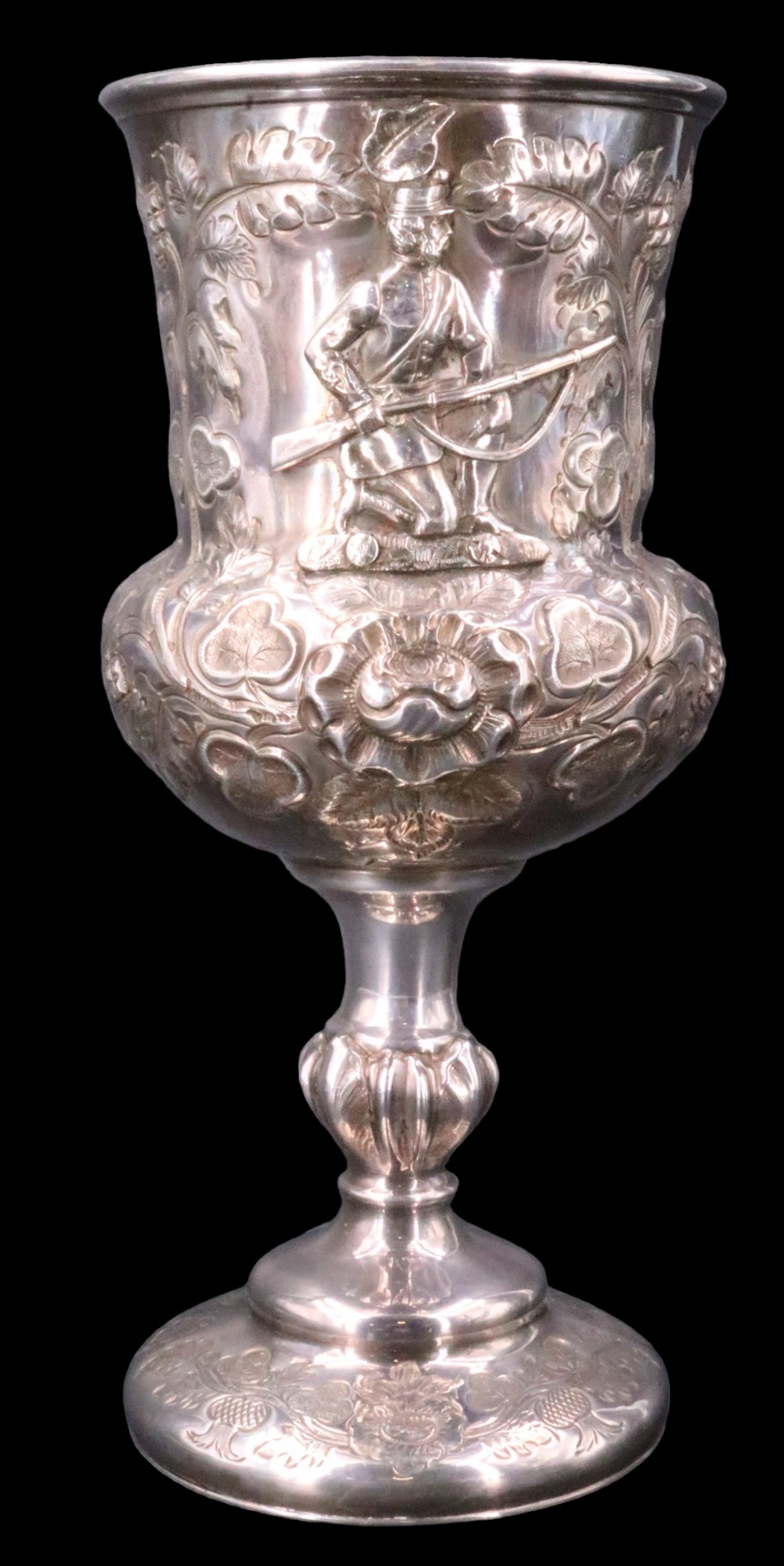 A Victorian electroplate Rifle Volunteer trophy cup, engraved and relief decorated in depiction of a