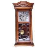 A 1930s walnut wall clock, having a two-train spring-driven movement striking on a gong, 37 x 20 x