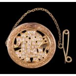 A late 19th Century diamond set monogram brooch, the pierced yellow metal letters set with