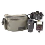 A Nikon F-501 AF 35 mm film camera together with an AF Nikkor 70-210 mm lens, and other accessories