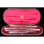 A cased Edwardian silver carving set, comprising two sizes of knife and fork together with a
