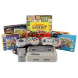 A Super Nintendo PAL Version video game console together with controllers, a boxed Super Gameboy