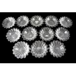 A set of 12 1960s pressed glass dessert bowls, of petal form