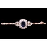 An early 20th Century sapphire and white spinel brooch, the 7.5 x 5.5 mm cushion cut blue sapphire