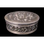 A 19th Century Dutch white metal pocket snuff or pill box, of oval section, its hinged lid relief