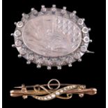 A late Victorian seed pearl and 9 ct yellow metal brooch, being a bar of adorsed scrolls having an