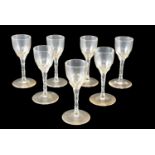 A set of seven early 19th Century free blown cordial glasses, having faceted stems and bowls, 11 cm