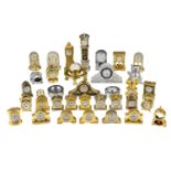 A quantity of miniature brass clocks, etc