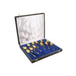 A cased set of twelve gold-plated O J Perrin naturalistic coffee spoons having bean terminals