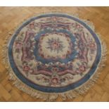 A circular wool-pile tassel rug, 140 cm diameter
