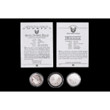 Three silver US coins, comprising a 2005 and a 1998 "Silver Eagle" dollar, and a 1995 "Special