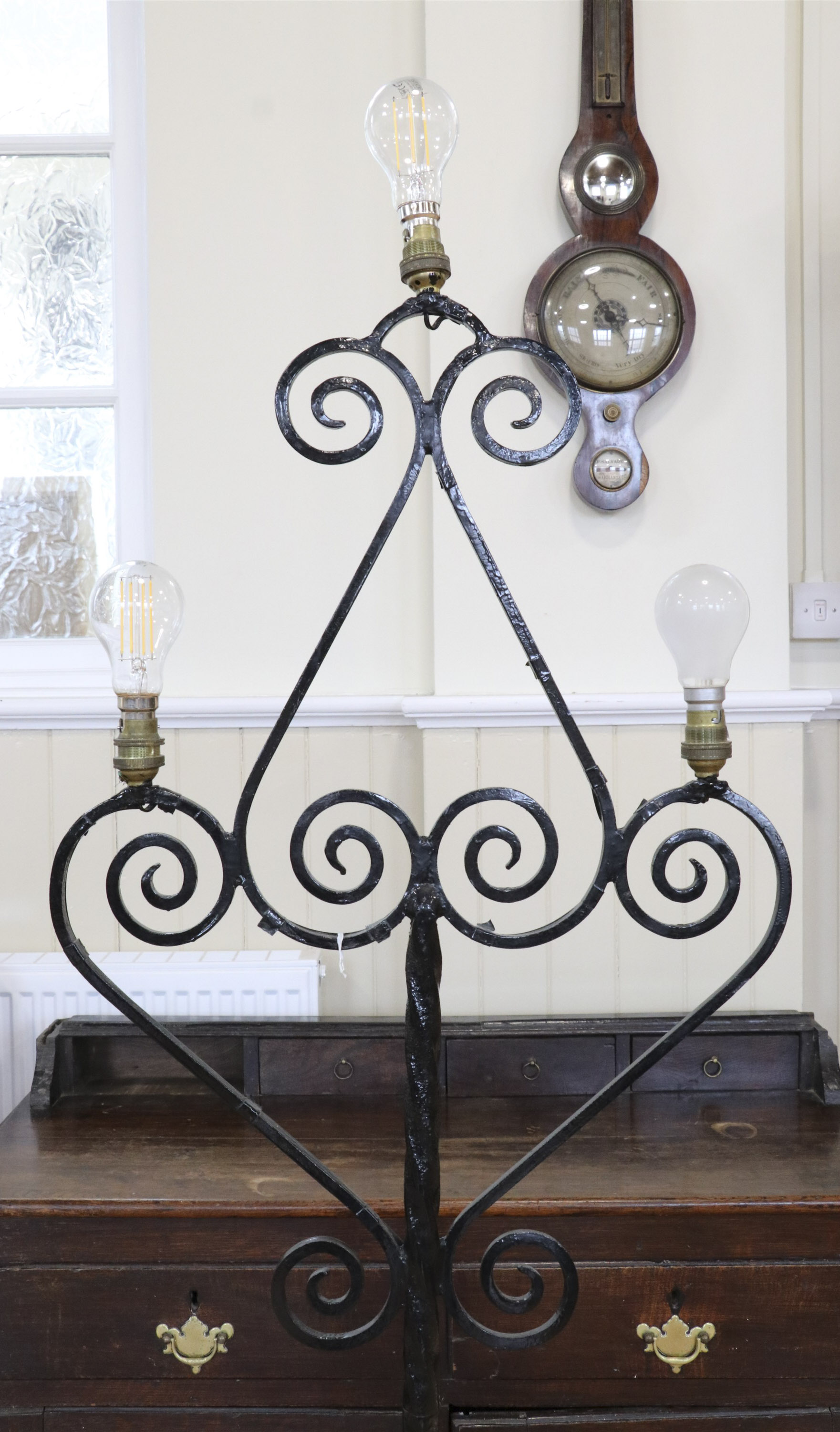 A mid-to-late 20th Century wrought iron standard lamp, comprising a tripod base and scrolled top - Image 2 of 2
