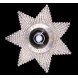 A Victorian Masonic Knight Templar silver star breast badge, centred by a bull's eye agate