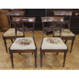 A set of four Regency mahogany stand chairs, having carved and turned front legs and drop-in seats,