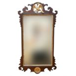 An old reproduction Chippendale style mahogany and parcel gilt fretwork mirror, having a ho-ho