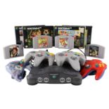 A Nintendo 64 video game console together with controllers and a group of games including Donkey