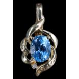 A late 20th Century topaz and diamond pendant, the 10 x 8 mm oval topaz surrounded by asymmetric