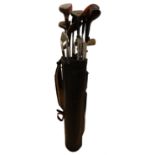 A bag of vintage golf clubs, including Swilken, Slazenger, etc