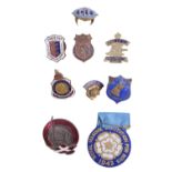 A small group of lapel badges including a 1943 Royal Masonic Institution for Boys token badge, an