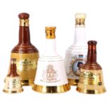 A set of three graduated Bell's ceramic decanters of whisky together with two others