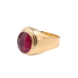 A mid 20th Century French ruby finger ring, having a faceted 9 x 7 mm oval ruby bezel set between