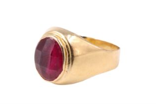 A mid 20th Century French ruby finger ring, having a faceted 9 x 7 mm oval ruby bezel set between