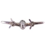 A white metal brooch in the form of a twin-engined bomber aircraft, having free-moving propellers,