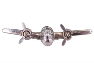 A white metal brooch in the form of a twin-engined bomber aircraft, having free-moving propellers,