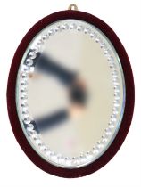 A Victorian bevelled edge sorcerer's mirror mounted on claret plush back, 32 cm x 44 cm overall