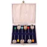 A cased set of silver coffee spoons, having coloured composition "bean" terminals, Sheffield,
