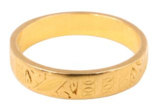 A 22 ct gold wedding band, of oblong section having engraved decoration, London, 1959, 3.86 g,