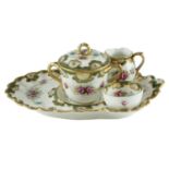 A late 19th Century continental porcelain boudoir coffee set, comprising a diminutive sugar bowl and