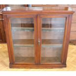 A Victorian glazed mahogany bookcase, having adjustable shelves with period faux leather dust